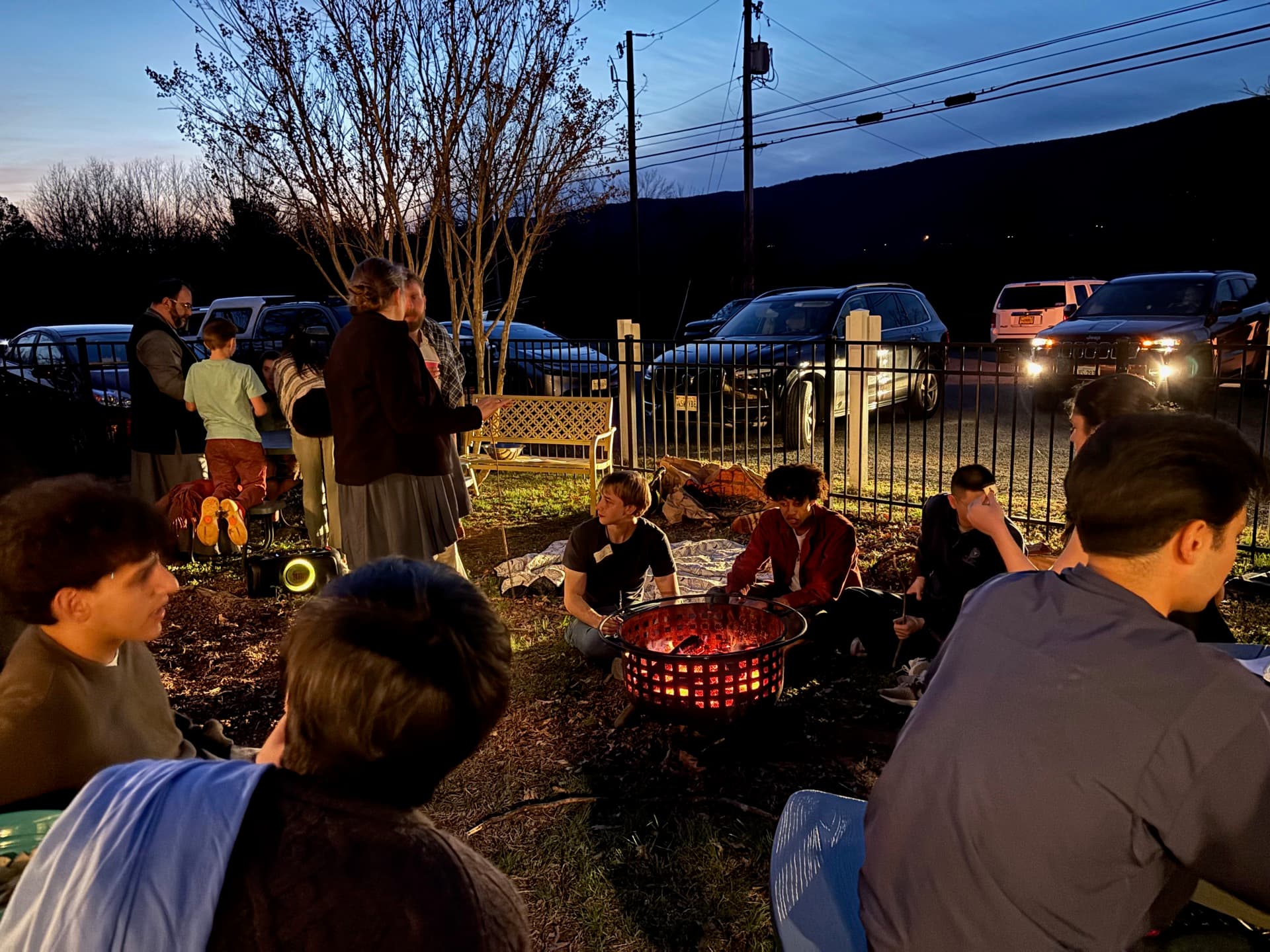 OCF students gathered around a bonfire in the evening