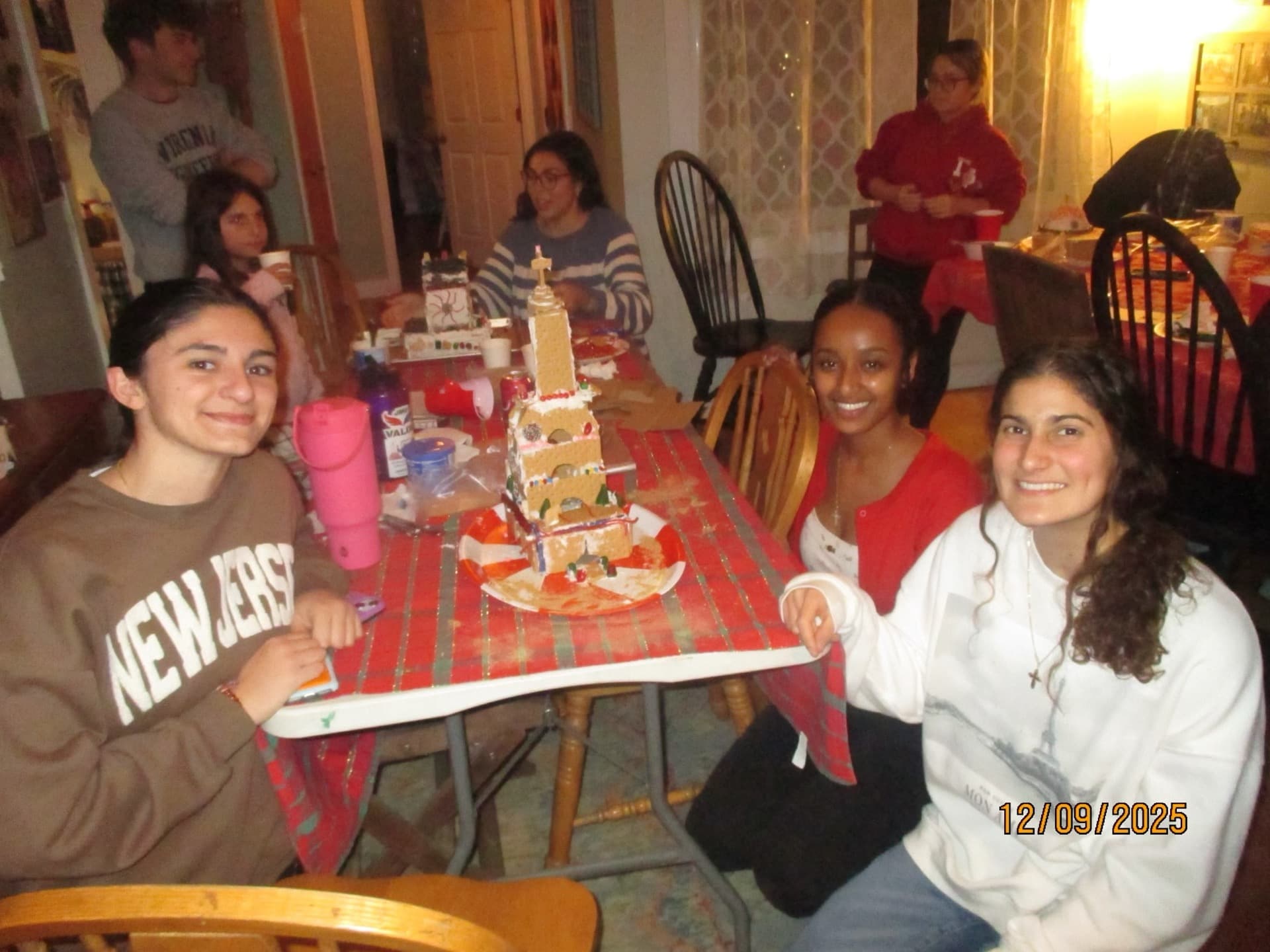 Students building a gingerbread church together