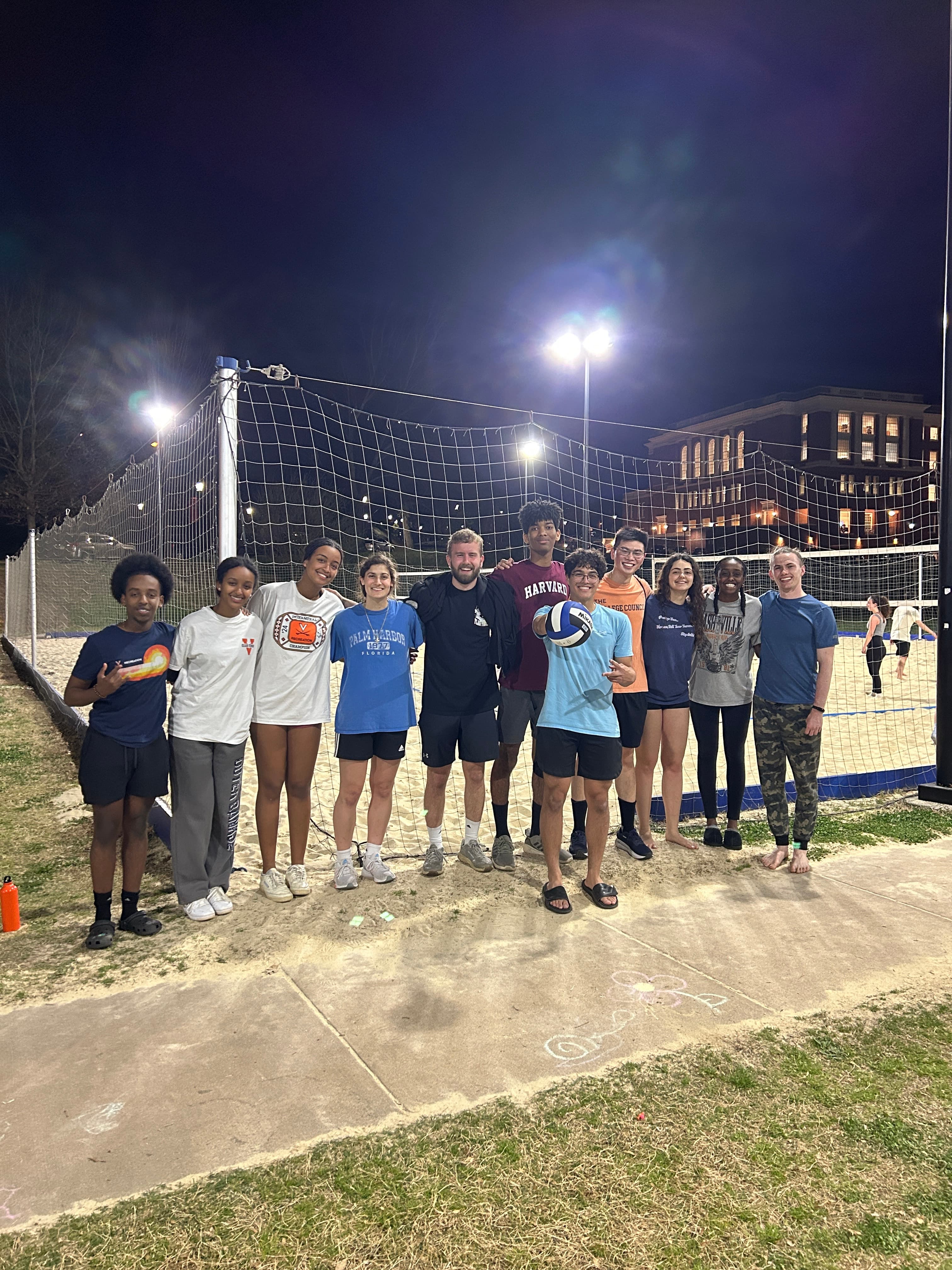 OCF students playing volleyball at night on UVA grounds